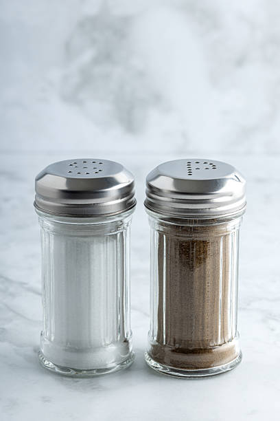 istock Salt and pepper shakers on marble surface 2210232111