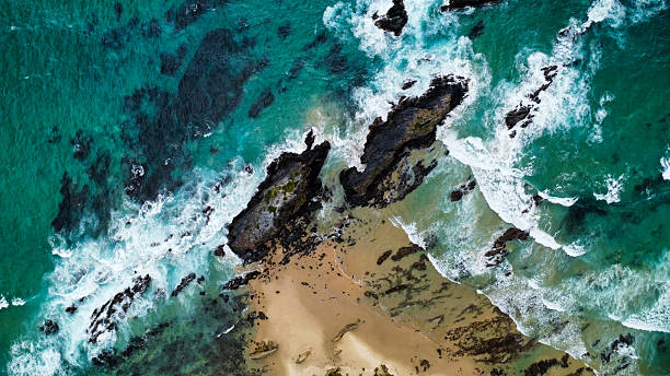 istock Rocks off the coast in rough seas, seen from above 2210234491
