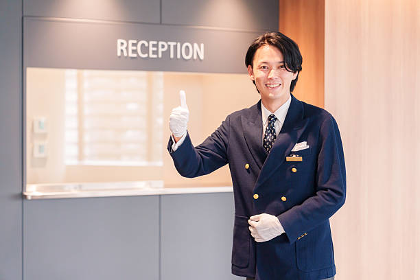 istock Hotel staff man serving customers with a smile. 2210235633
