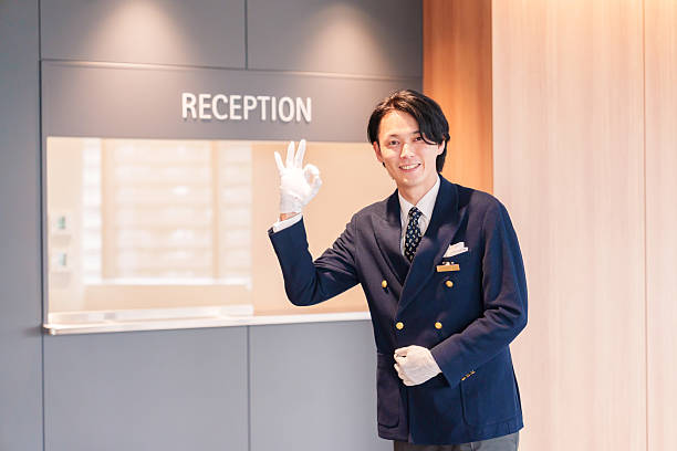 istock Hotel staff man serving customers with a smile. 2210235634