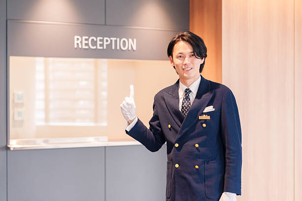 istock Hotel staff man serving customers with a smile. 2210235639