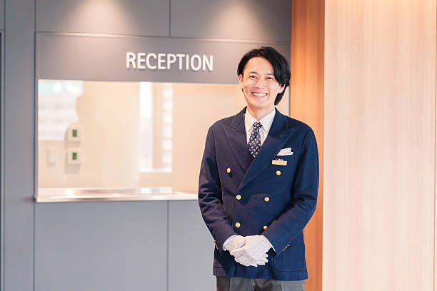 istock Hotel staff man serving customers with a smile. 2210235647