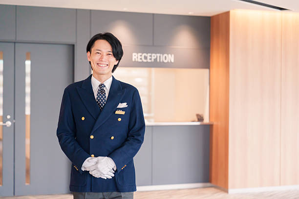 istock Hotel staff man serving customers with a smile. 2210235661