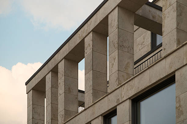 Modern building facade with stone columns reaching for the sky