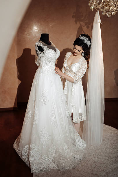 istock A woman is getting ready for her wedding and is adjusting her dress 2210236554