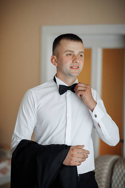 istock A man in a suit and tie is getting ready to go out 2210236596