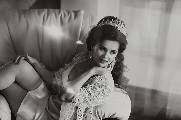 istock A woman in a white gown sits on a couch 2210236690