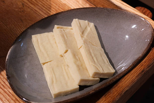 istock uncooked raw tofu ( bean curd) cut in rectangle on a plate shape for hot pot 2210238141