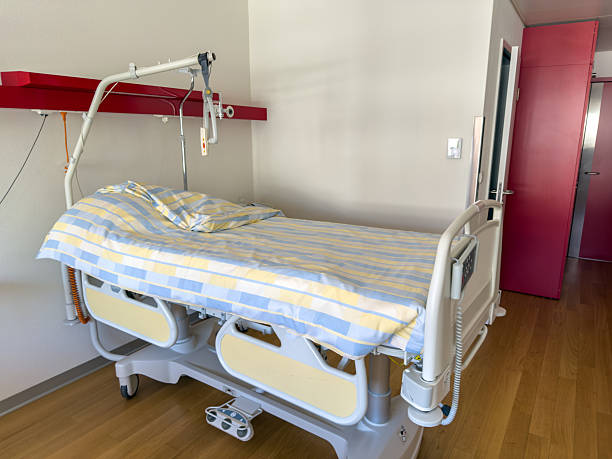 istock Hospital Bed in Private Room with Striped Linens 2210238554