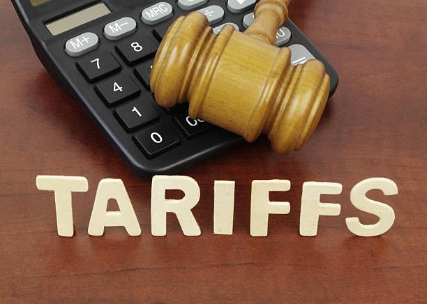 istock Wooden judge gavel and calculator with word tariffs. 2210240218