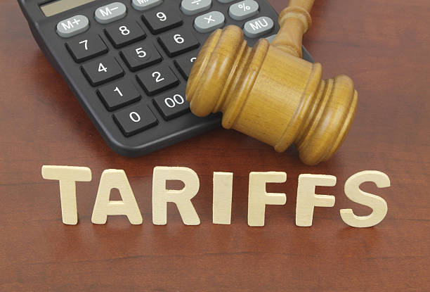 istock Wooden judge gavel and calculator with word tariffs. 2210240261