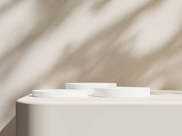 istock Close up view of white podiums casting long shadows, creating a serene and minimalistic atmosphere. 2210241619