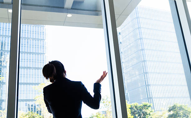 istock Businesswoman using smart phone near the window 2210241844