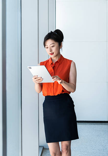 istock Businesswoman using digital tablet near the window 2210241898