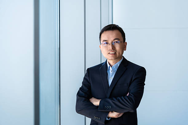 istock Businessman standing in office with crossed arms 2210242663