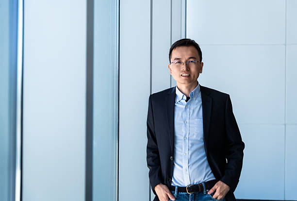 istock Businessman standing in office with hands in pockets 2210242672