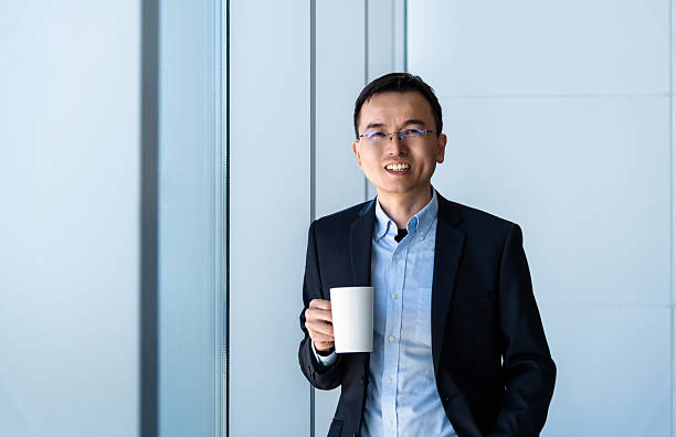 istock Businessman holding a coffee cup near the window 2210242929