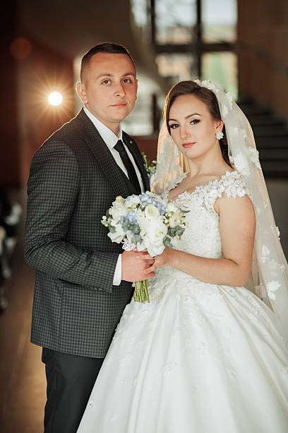 istock A bride and groom are posing for a picture 2210243350