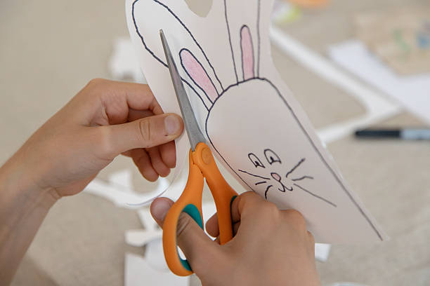 istock A child carefully cuts out his or her bunny, practicing fine motor skills, scissor control, and autonomy through a creative activity. 2210249786