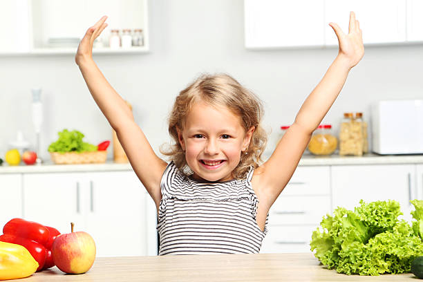 istock Little girl sitting in the kitchen 2210249867