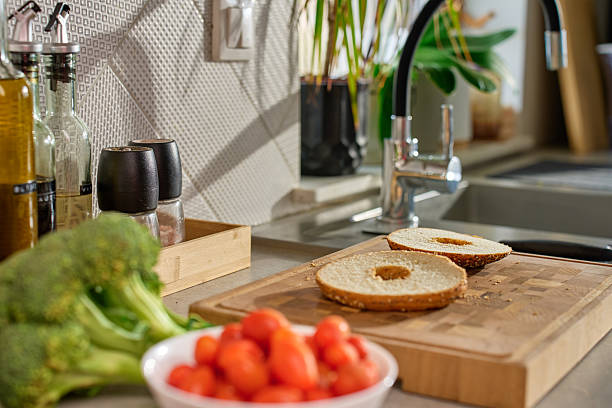 istock Preparing bagel sandwich with fresh ingredients in kitchen 2210251734