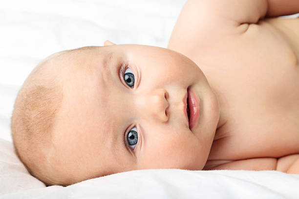 istock Little newborn baby on white bed 2210251887