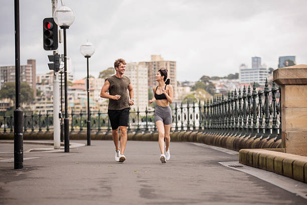 istock Couple Jogging Together in Downtown Sydney 2210252504
