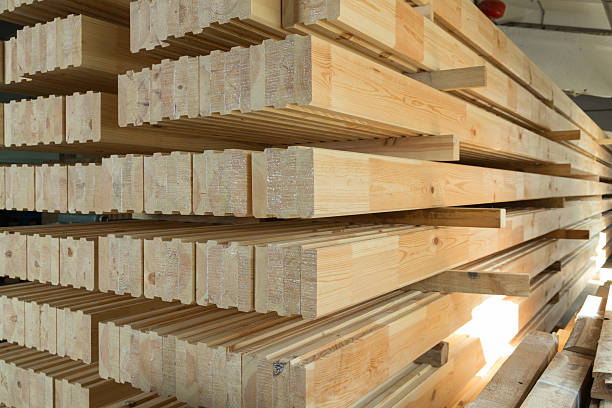 istock Stack of  glued wooden beams used for house development 2210253372