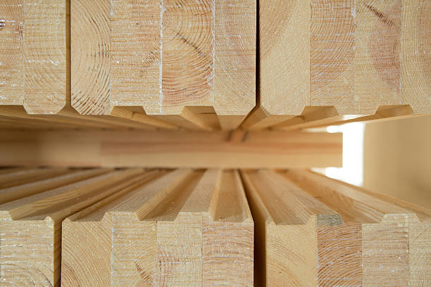 istock Stack of  glued wooden beams used for house development 2210253373