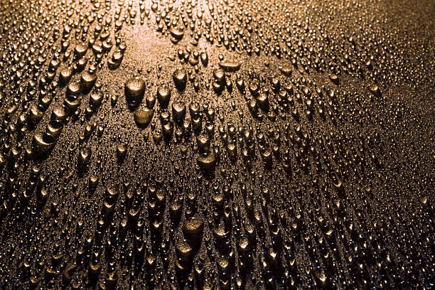 istock Bronze wrinkled background with raindrops 2210253711