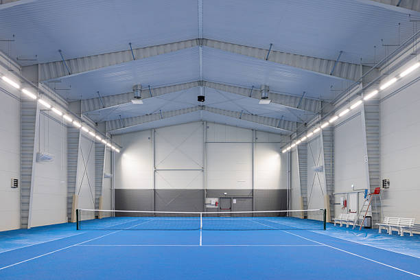 istock Bright and Airy Indoor Tennis Arena with Blue Surface 2210253744