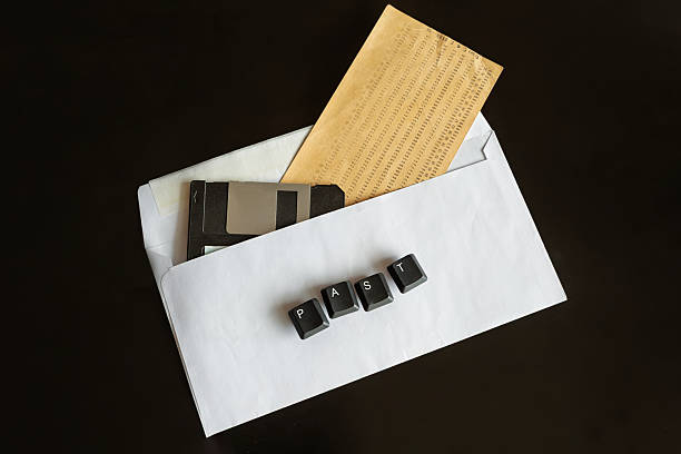 istock An old punch card and computer floppy disk in a white envelope with the word 
