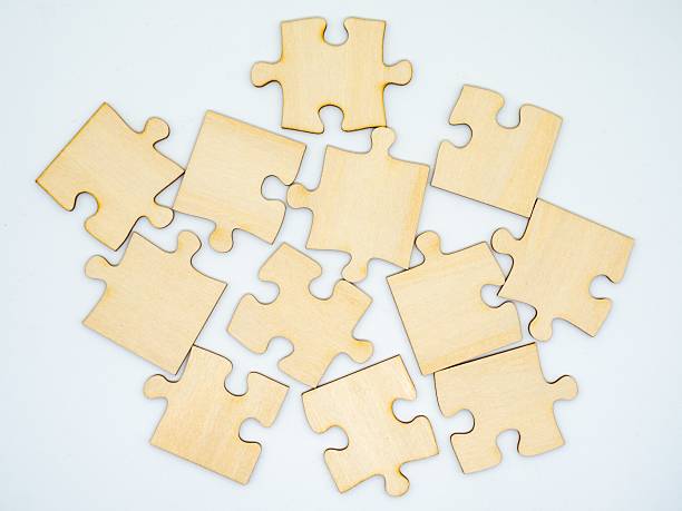 istock Wooden Puzzle Pieces on White 2210255208