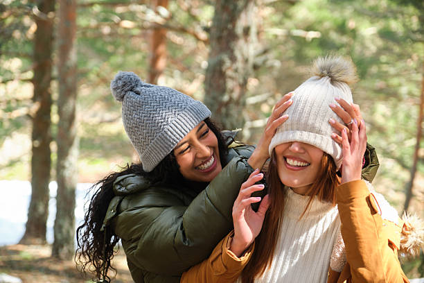 istock Two happy young women playing in the forest during wintertime 2210256010