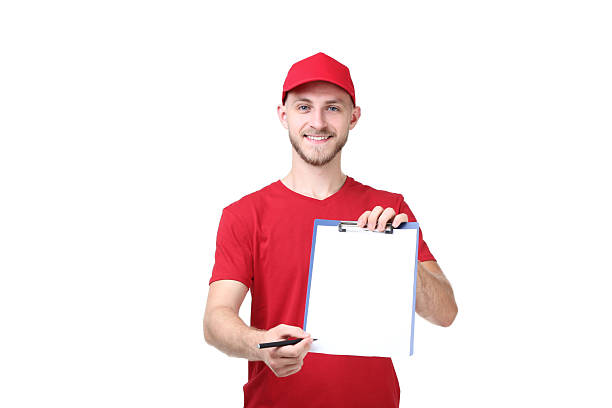 istock Delivery man in red uniform with clipboard on white background 2210256963