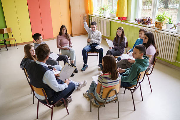 istock Children sit in a classroom in a circle with their teacher 2210257120