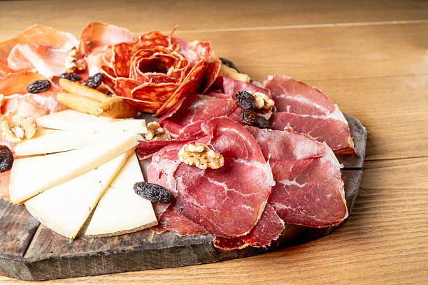 istock Delicious charcuterie board presenting cured meats, cheese, and nuts 2210257841