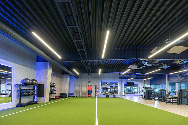 istock Modern Gym Interior Featuring Equipment and Green Flooring Under Sleek Lighting 2210258021