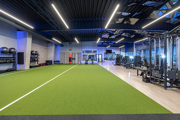 istock Modern Gym Interior with Exercise Equipment and Artificial Turf Track 2210258261