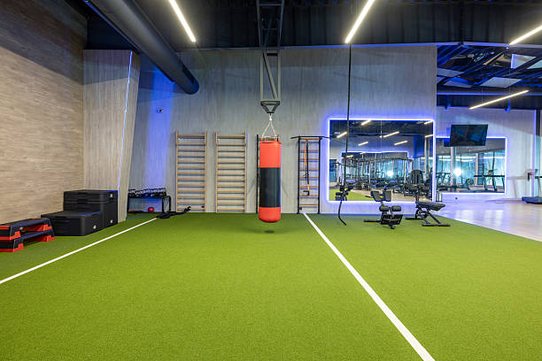 istock Modern Gym Interior with Workout Equipment and Green Training Area 2210258281