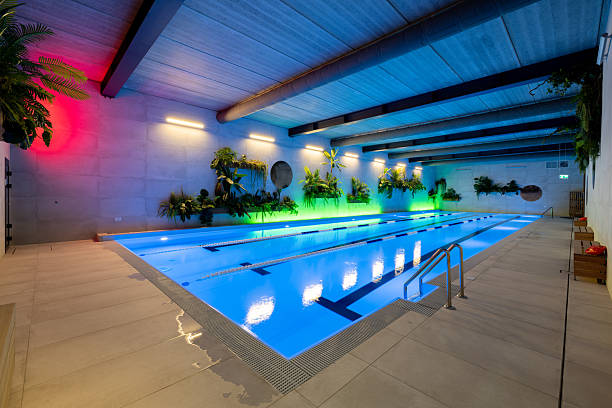 istock Indoor Pool with Colored Lights and Greenery Decor Enhancing Relaxation 2210258684