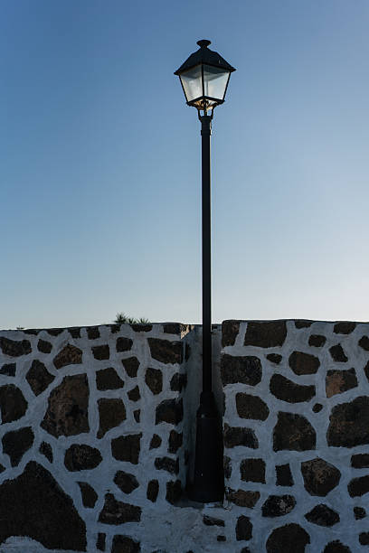 Street lamps on brick wall at night. Shot in Madrid, Spain
