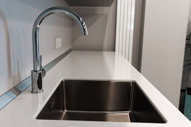 istock The kitchen sink with a mixer is clean in the kitchen 2210261157