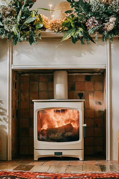 istock A fireplace with a white stove and a brick mantle 2210262768
