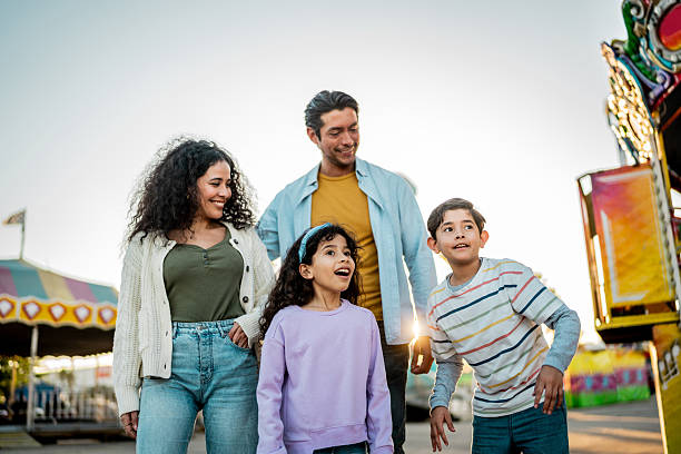 istock Family talking at amusement park 2210265460