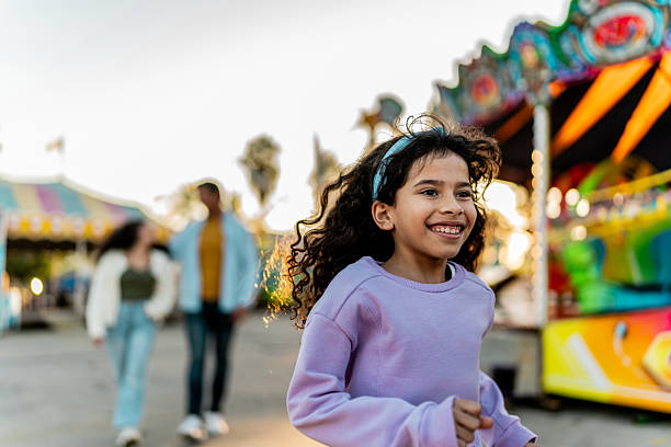 istock Child girl running on amusement park 2210265468