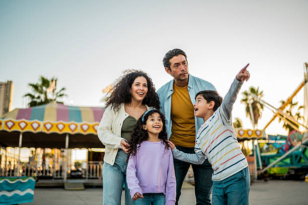 istock Family talking at amusement park 2210265472