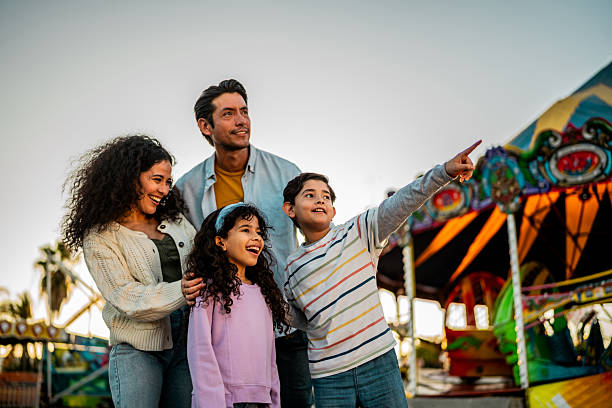 istock Family talking at amusement park 2210265478