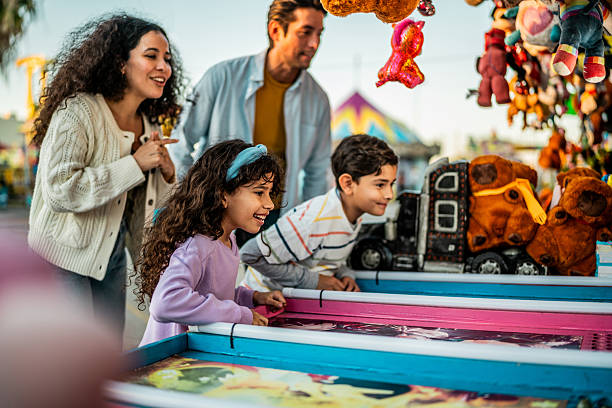 istock Family playing game on carnival booth 2210265483