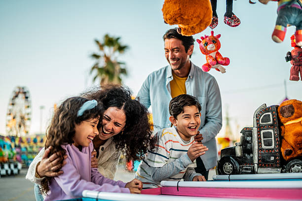 istock Family playing game on carnival booth 2210265486